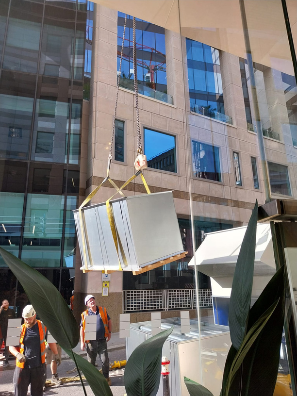 AHU section being crane lifted into position at Blackfriars, viewed from inside the office building