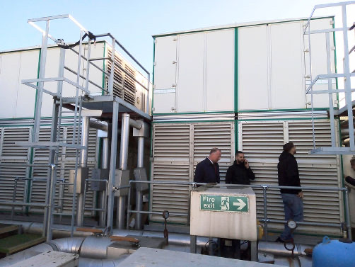 Engineers conducting ventilation survey on rooftop AHU equipment at Disney HQ Hammersmith