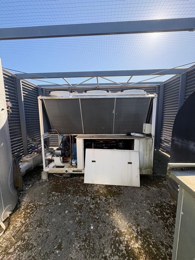 Old, weathered condenser unit removed during the AHU refurbishment at the East London academy