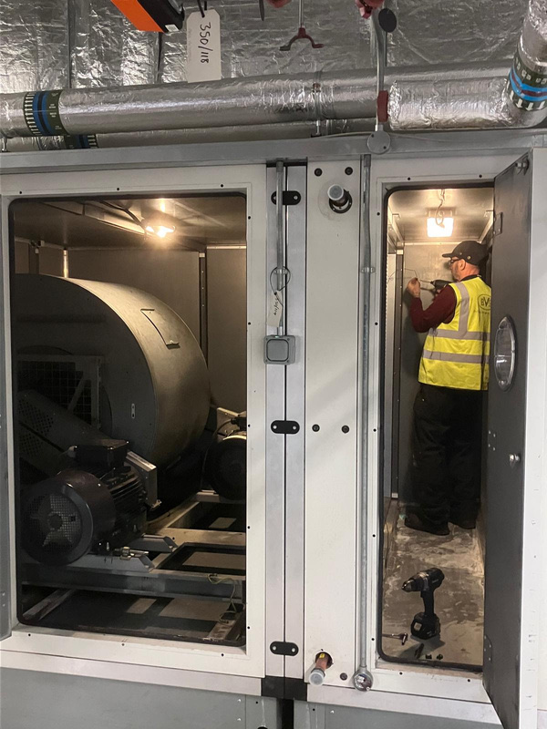 Large belt-drive fan AHU at pharmaceutical manufacturing facility where BVS replaced the heating coil