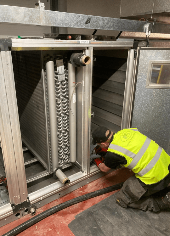 Building Ventilation Solutions engineer carrying out work on an Air Handling Unit.