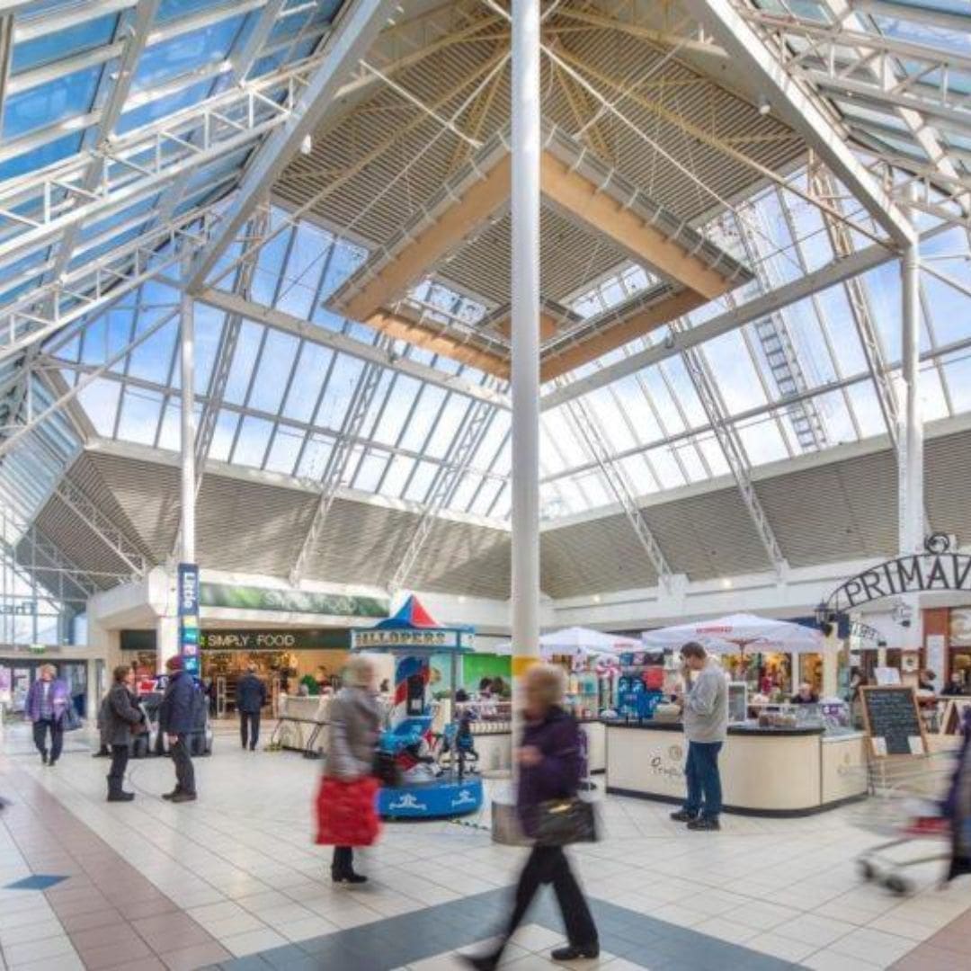 Modern shopping centre interior in Glasgow with natural light from glass roof – example of completed AHU refurbishment and upgraded pipework ventilation solutions ensuring improved indoor air quality and energy efficiency